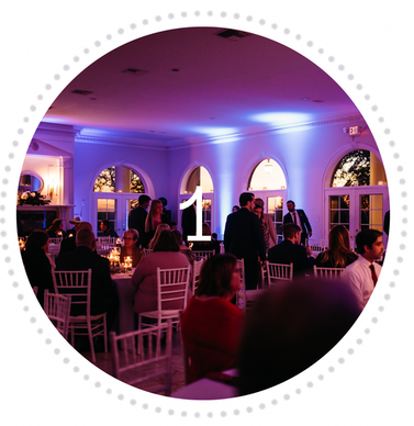 Full bar party wedding venue hill country lights dancing people having fun at wedding party.